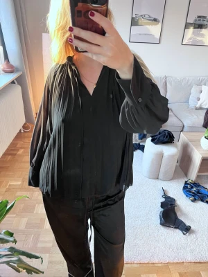 Svart plisserad blus med v-ringning - Blus, plisserad, v ringning