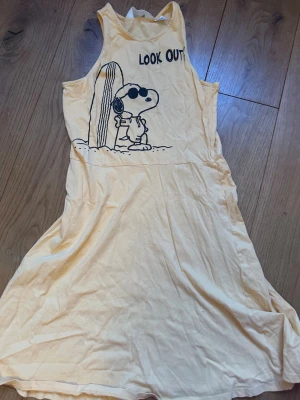 Orange klänning med Snoopy - Orange klänning med Snoopy i barnstorlek 170