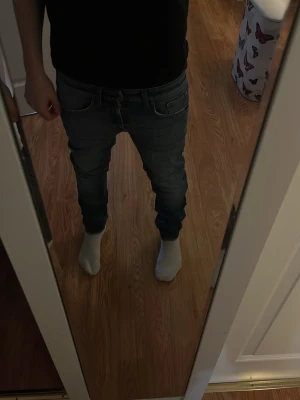 Blå slim fit jeans  - Säljer ett par blå slim fit jeans och klassiska fem fickor. Jeansen har en snygg tvättad look och smal passform som sitter tajt längs benen. Perfekta till vardagsstilen och funkar till det mesta. Materialet är stretchigt denim för extra komfort.