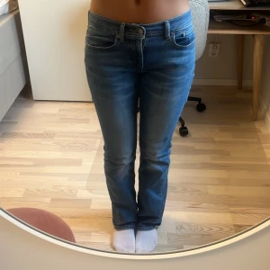 Blå jeans - Säljer ett par snygga blå jeans med en klassisk look. De har en lågmidjad passform och är bootcut. Perfekta för vardagsbruk och kan matchas med nästan vad som helst! Säljer pågrund av att de inte passar. (Inte min bild)