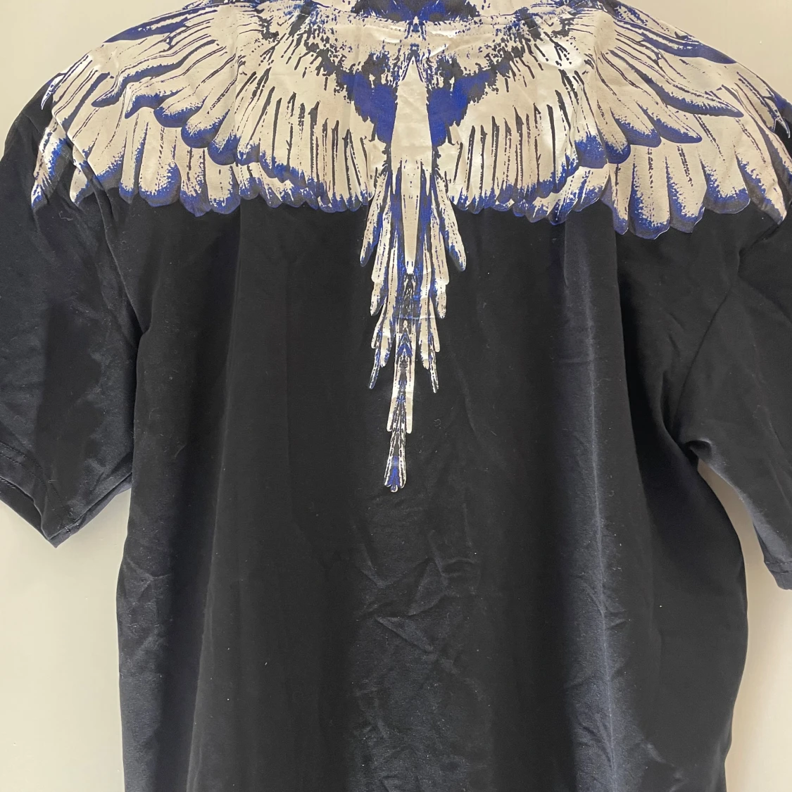 Svart t-shirt med blått och vitt fjädertryck - 1