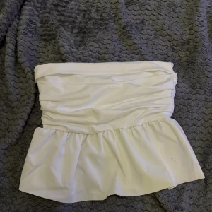 Vit volang tubtopp - Säljer en snygg vit tubtopp med volangkant nertill.🤍
