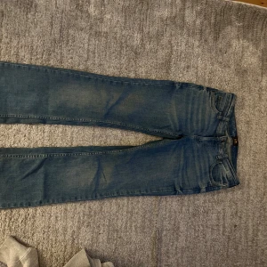 Blå Lee Jessica jeans W25 L31 - Säljer ett par klassiska blå jeans från Lee, modell Jessica. Jeansen har en rak passform med normal midja och fem fickor. Snyggt Lee-märke på bakfickan och diskret tvättad look. Perfekta till en avslappnad stil och funkar året runt. Jeansen är snyggt uppsydda med några centimeter.