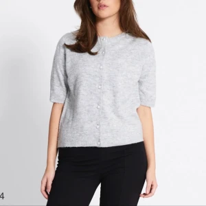 Ljusgrå tröja med pärlknappar - Superfin ljusgrå kofta med korta ärmar och pärlknappar framtill. Stolek S