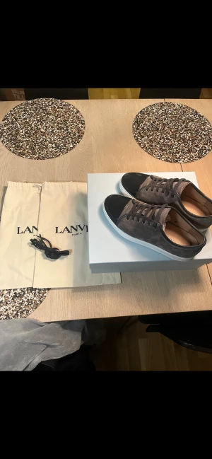 Lanvin grå mocka sneakers med svart tå - Säljer nu dessa feta grå lanvins eftersom jag inte passar dom lägre. Dom är i ett väldigt fint skick och använd ett få tal gånger. Storlek  Uk 9  som motsvarar 43-44! Box dustbag och extra snören föjer med. Pris 2999kr✅ hör av er vid andra frågor!🔥