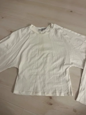 Vit långärmad tröja från lager - En vit långärmad med breda armar och smal midje tröja