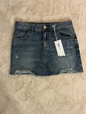 Jeanskjol  - Jeanskjol från gina tricot! Aldrig använd och har prislappen kvar😋köpte den i somras, den sitter väldigt fint på💕(skriv till mig för bild på)