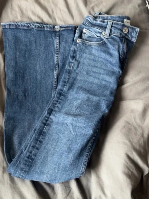 Blå bootcut jeans  - Snygga blå jeans från Perfect Jeans i klassisk modell med normal passform. Jeansen har fem fickor, dragkedja och knapp framtill samt bälteshällor. Perfekta till din vardagsstil och lätta att matcha med olika outfits. Köpta från Gina Tricot, använda men fortfarande i superfint skick! 