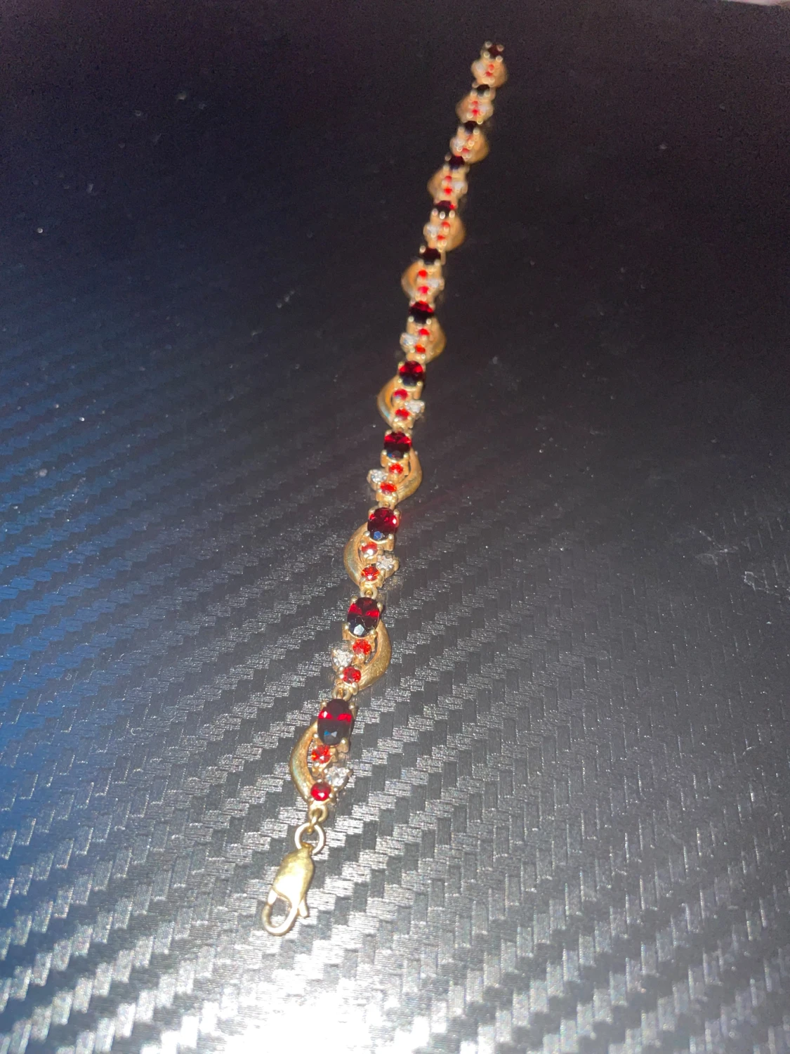 ARMBAND, förgyllt silver med granater och vita stenar. - 1