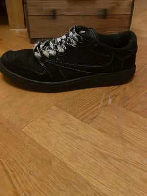 Svarta Nike sneakers med mönstrade snören - Ett par Travis scott skor ‼️äkta‼️ändå problem är lite färg har försvunnit från tårna och ett litet slitage på båda hälarna men allt är fixat t och me tårba har jag försökt fixa syns fortfarande lite men det ser mycket bättre ut        Går att lämna in till skomakare. Tveka inte att fråga något svarar snabbt 