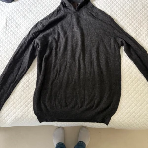 Mörkgrå hoodie från Oscar Jacobson - Säljer en  mörkgrå Pascal hoodie från Oscar. Perfekt för dig som vill ha en klassisk och bekväm look med premiumkänsla.