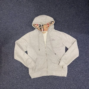 Grå hoodie från Burberry med dragkedja - Säljer en as det zip hoodie från Burberry. Storlek M. Pris 449kr, men kan såklart diskuteras!!