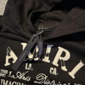 Amiri hoodie - Svart hoodie från Amiri med stor vit broderad logga och text på bröstet. Skriv vid minsta lilla fundering🙌 storlek S men sitter som M