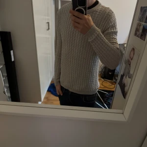 Grå Kashmir tröja från lexington - Säljer en ljusgrå stickad tröja från Lexington i storlek M. Tröjan har ett snyggt kabelstickat mönster, varm och skön som funkar riktigt bra till hösten. Perfekt för dig som gillar klassisk och clean stil. Tröjan passar dig som har storlek s-m. Priset är inte fast så hög av er vid frågor!😁 Tröjan är ej använd!