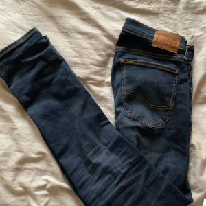 Mörkblå jeans från Lee - Snygga mörkblå jeans från Lee i storlek 28/32. Perfekta för en stilren look.