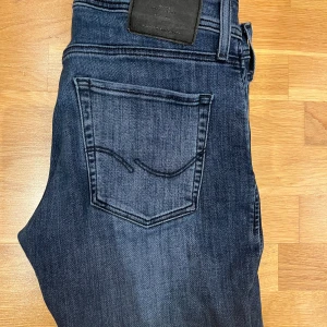 Jack ans Jones/Slim/Glenn - Ett par nästan helt nya Jack and Jones jeans i Slim\Glenn som sitter riktigt skönt med en mycket snygg blå färg! Knappt använd. Skick 10/10. Storlek 31/32 Fråga vid funderingar!