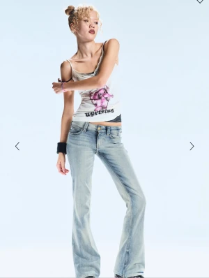 Blå bootcut jeans från Cheap Monday - Säljer ett par ljusblå bootcut jeans från Cheap Monday med klassisk femficksdesign och låg midja. Jeansen har en snygg tvätt med slitningar och logotyppatch bak i midjan. Perfekt passform och cool retrostil. Strl 29/34 relativt nya