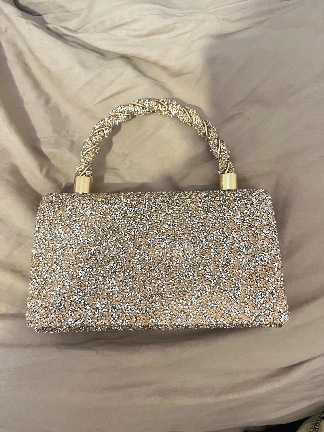 Glittrig guld handväska med flätat handtag