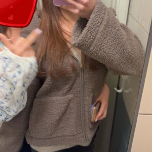 teddyjacka/ pilejacka - Mysig brun teddyjacka / piljacka från lager 157 perfekt till hösten. Jackan har en hel dragkedja och bred krage, perfekt för lager-på-lager. Materialet är fluffigt och ger en chill vibe, passar till jeans eller mjukisbyxor. Storlek M