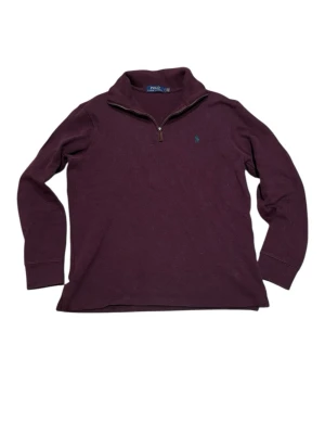 Polo Ralph Lauren Half-Zip Sweater - Burgundy - Size S - Classic Polo Ralph Lauren quarter-zip pullover in a beautiful deep burgundy/wine red color. Features the iconic pony logo embroidered in contrasting teal on the chest. A timeless piece perfect for the "Old Money" or preppy aesthetic.  Brand: Polo Ralph Lauren  Size: Small (S)  Color: Burgundy / Dark Red  Material: 100% Cotton (Check label to confirm)  Condition: Good vintage condition. Well-cared for with plenty of life left. Minor fault with stitching in neck.