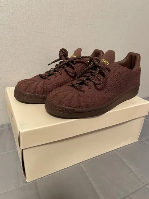 adidas x Pharrell Superstar PK – EU 40⅔ – Good condition - adidas x Pharrell Williams Superstar PK sneakers.  Used, in good condition. Shoes are structurally solid with normal wear. Cleaned carefully, but since the upper is fabric (Primeknit) and I have a dog, a stray hair or two may remain.  Original box included (box has some wear). No original paper inside the box.  Size: EU 40⅔ / US 7.5 Style code: S42926  Message me if you want more photos or info. 