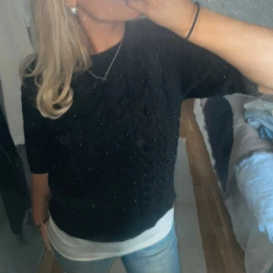 Svart stickad tröja med pärlor - Snygg svart stickad tröja med korta ärmar och små svarta pärlor på. Endast testad så i bra skick och passar xs-m💕