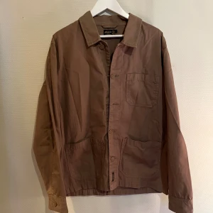 Morris Overshirt brun - Säljer denna sjukt snygga Overshirten från Morris⭐️ Färgen är brun och storleken är M✅ Två knappar saknas därav priset men annars toppskick🙌🤝 Sjukt najs passform och passar perfekt till hösten🍁🙌 Tveka inte på att höra av er dig vid minsta fråga eller fundering😊