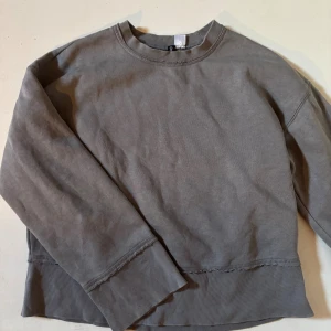 Grå sweatshirt - Jättecool grå sweatshirt från H&M med lite slitna detaljer. Så snygg passform och perfekt till hösten!