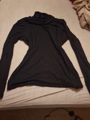 Svart polotopp från Esmara - Säljer en svart polotopp från Esmara i storlek S. Toppen har lång ärm och en klassisk polokrage som ger en clean och stilren look. Materialet är mjukt och stretchigt, perfekt att styla till olika outfits. Priset kan diskuteras🫶