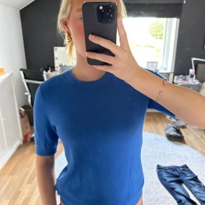 Blå stickad kortärmad tröja - Blå och mjuk tröja från Zara. Tröjan har knappar i nacken🥰