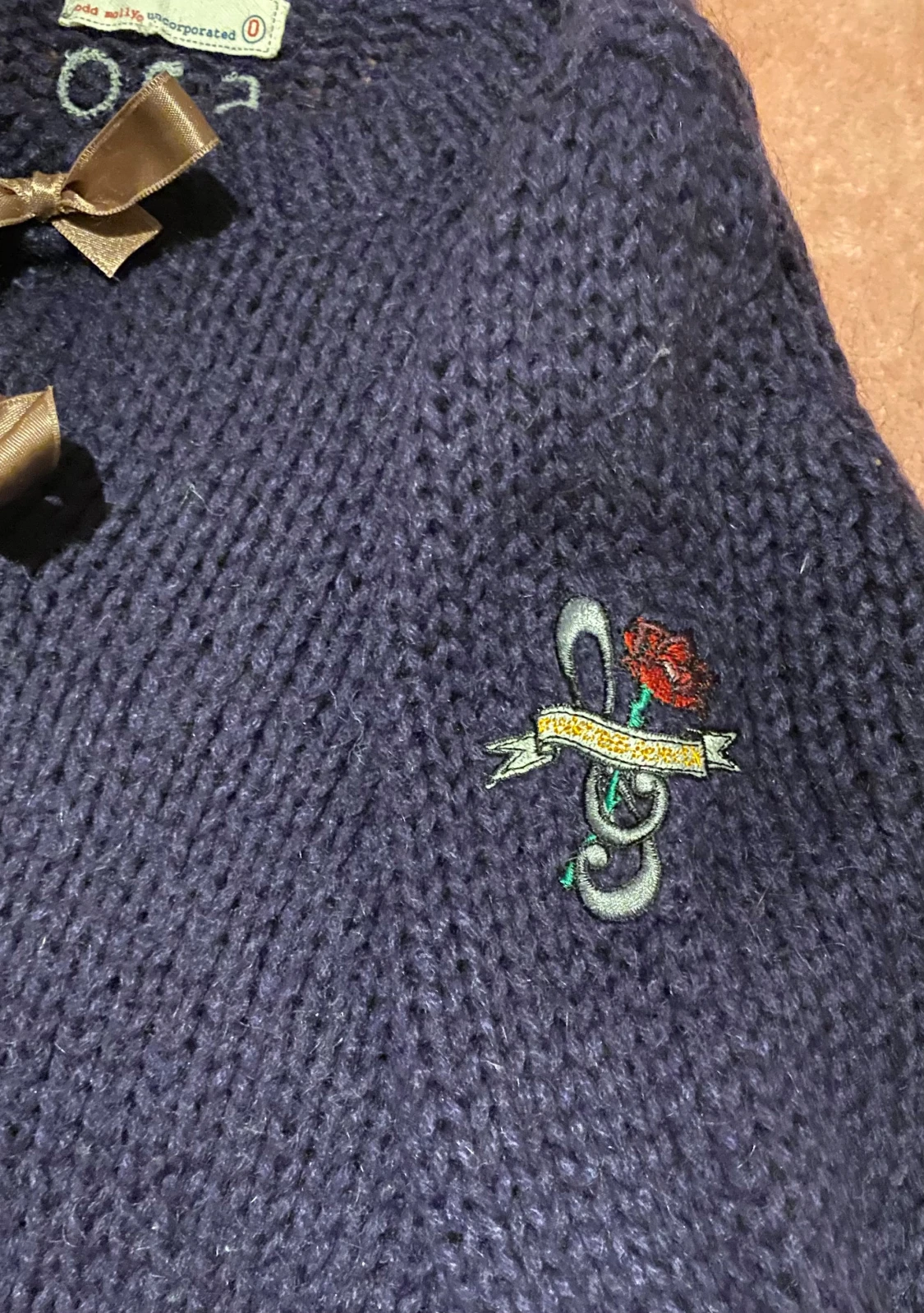 Mörkblå kofta från Odd Molly med rosetter i storlek 0 - 1