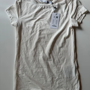 Vit basic t-shirt i bomull XS - En enkel vit t-shirt från lager 157. Storlek XS, aldrig använd. 