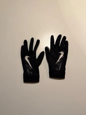 Svarta Nike handskar  - Snygga svarta Nike handskar till fotboll och annat. Säljer på grund av att dem är för små. Passar till 8-11 år.