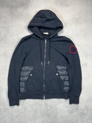 Moncler hooded cardigan jacket - – Condition: 8/10 - general wear  - Size: M  – Retail price: 10 000 + SEK  Please note that Moncler runs small, we recommend going up one size from your usual size