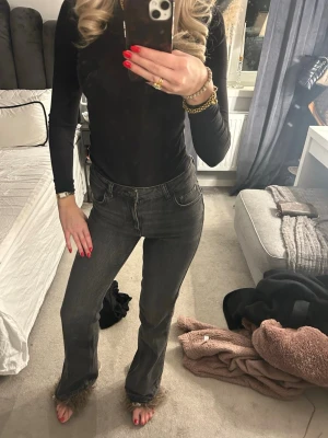 Mörkgrå bootcut jeans midwaist - Säljer ett par mörkgrå jeans med bootcut passform och hög midja. Jeansen har klassisk femficksdesign och är tillverkade i jeansmaterial. De är stretchiga 