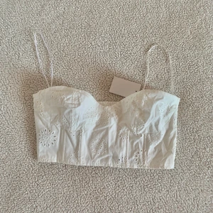 H&M crop top / bustier topp med hålbroderi - Aldrig använd, ny med tags kvar.
