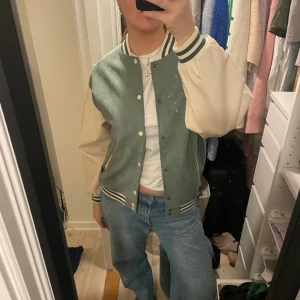 Collegejacka - As cool turkos mocka collegejacka med vita skinn ärmar. Köpt i en vintage butik i Tokyo. Knappt använd och i mycket bra skick.  Står ingen storlek i jackan men skulle säga att den sitter som en 38 oversized