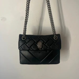 Kurt Geiger väska - Supersnygg Kurt Geiger väska i färgen svart och modellen mini. Nypris: 2500kr. Väskan är i mycket bra skick och totebag tillkommer. Det är bara att kontakta mig vid eventuella funderingar.