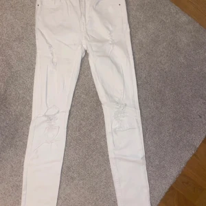Vita skinny jeans - Vita skinny jeans med hål på knäna. Storlek 34