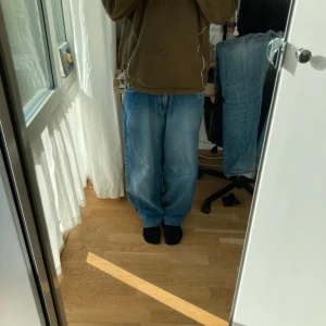 Tribal baggy Jeans - Riktigt sköna blåa baggy jeans men snygga detaljer som på bakfickan och ett coolt märke på vänster fickan. Storlek 32. 