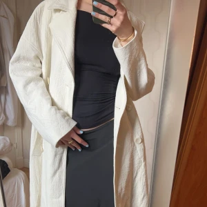 Vit kappa - Vit kappa från zara jag köpt från Sellpy som jag aldrig använt. Kappan är i bra skick däremot har den en foundation fläck på insidan, går kanske att tvätta bort. Den slutar strax vid mina vader och jag är 164cm lång💕