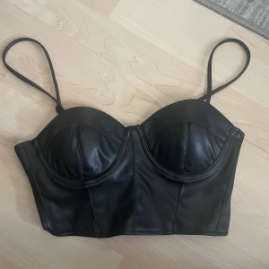 Snygg topp - En jättecool topp i läder. Storlek S.  Använd endast en gång. Säljer då den inte passade mig.  Bra skick. :) 