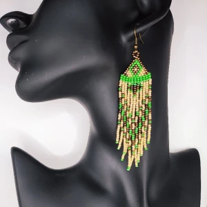 Handgjorda örhängen  - Dessa är handgjorda av min mamma som designar sina egna smycken. De är vävda med små glaspärlor. De är inte riktigt så lysande gröna som på första bilden.  9 cm långa är dessa. 