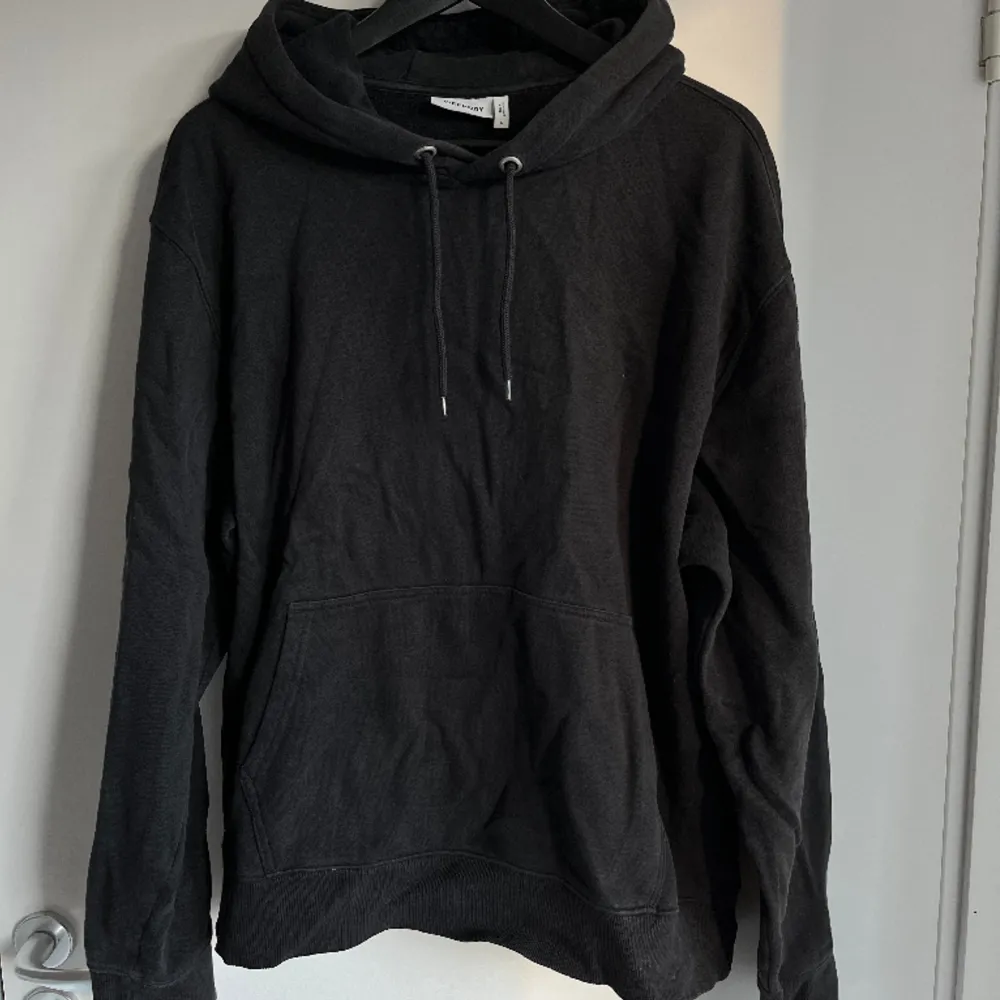 Normal fit svart hoodie från Weekday som inte används längre, storlek L. . Hoodies.