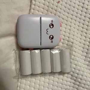 Skrivare bläckfri - Skriver ut genom en app, har använts 2 gånger. Kommer med en laddare och pappersrullar. Behöver inget bläck för att skriva ut. Nypris 399:-