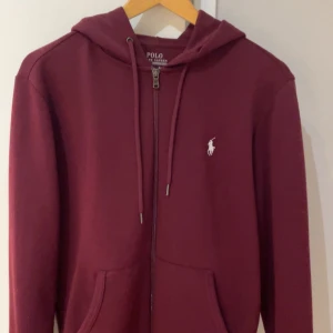Polo Ralph lauren hoodie  - Säljer en polo Ralph lauren hoodie i vinröd som är väldigt unik och inte går att få tag i längre någonstans. Använd väldigt fåtal gånger så 9/10 skick. Storlek S