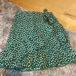 jättefin grönblommig kjol med volang och knyte på höften.