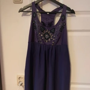 Klänning - Lila klänning med pärlor.