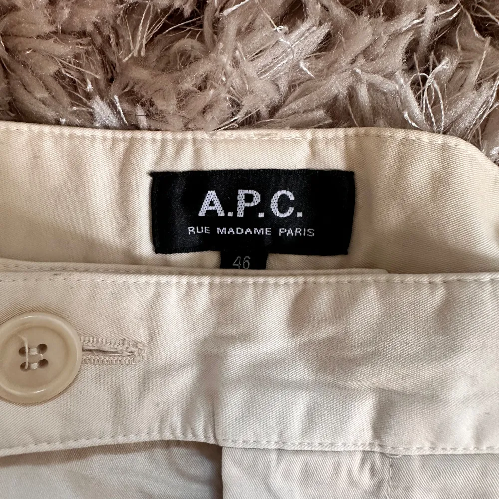 APC Renato Trouser Size: 46 Moderate carrot cut. Wide leg. Darts at waist on front. Offset buttoned tab closure. Zip fly. Side pockets. Back flap pocket. Worn twice / w with original bag. Farkut & Housut.