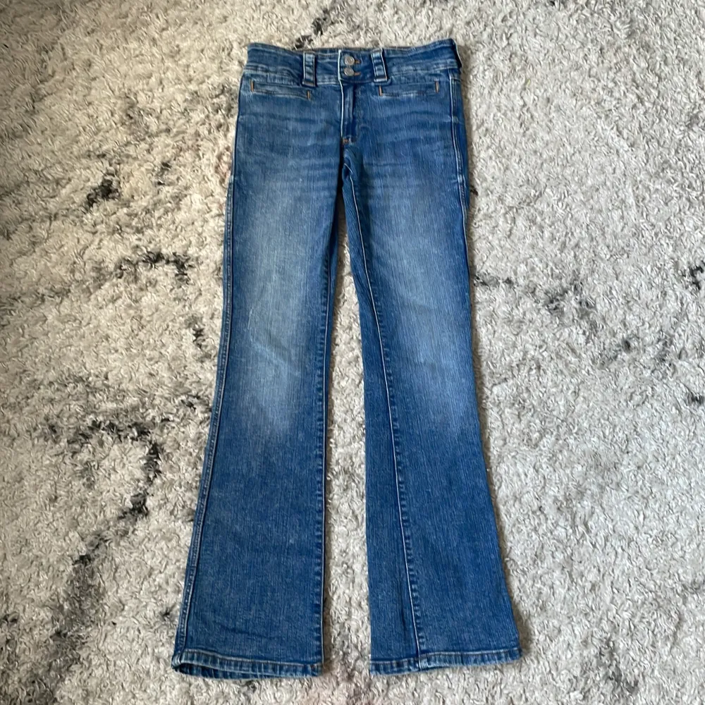 Säljer ett par snygga blå lågmidjade bootcut jeans✨ Jeansen är i från h&m och är köpta för 279kr  (tror jag) de har inga defekter🫰🏻De är i storlek 164 men skulle säga att de är små i storleken💙🤍. Jeans & Byxor.